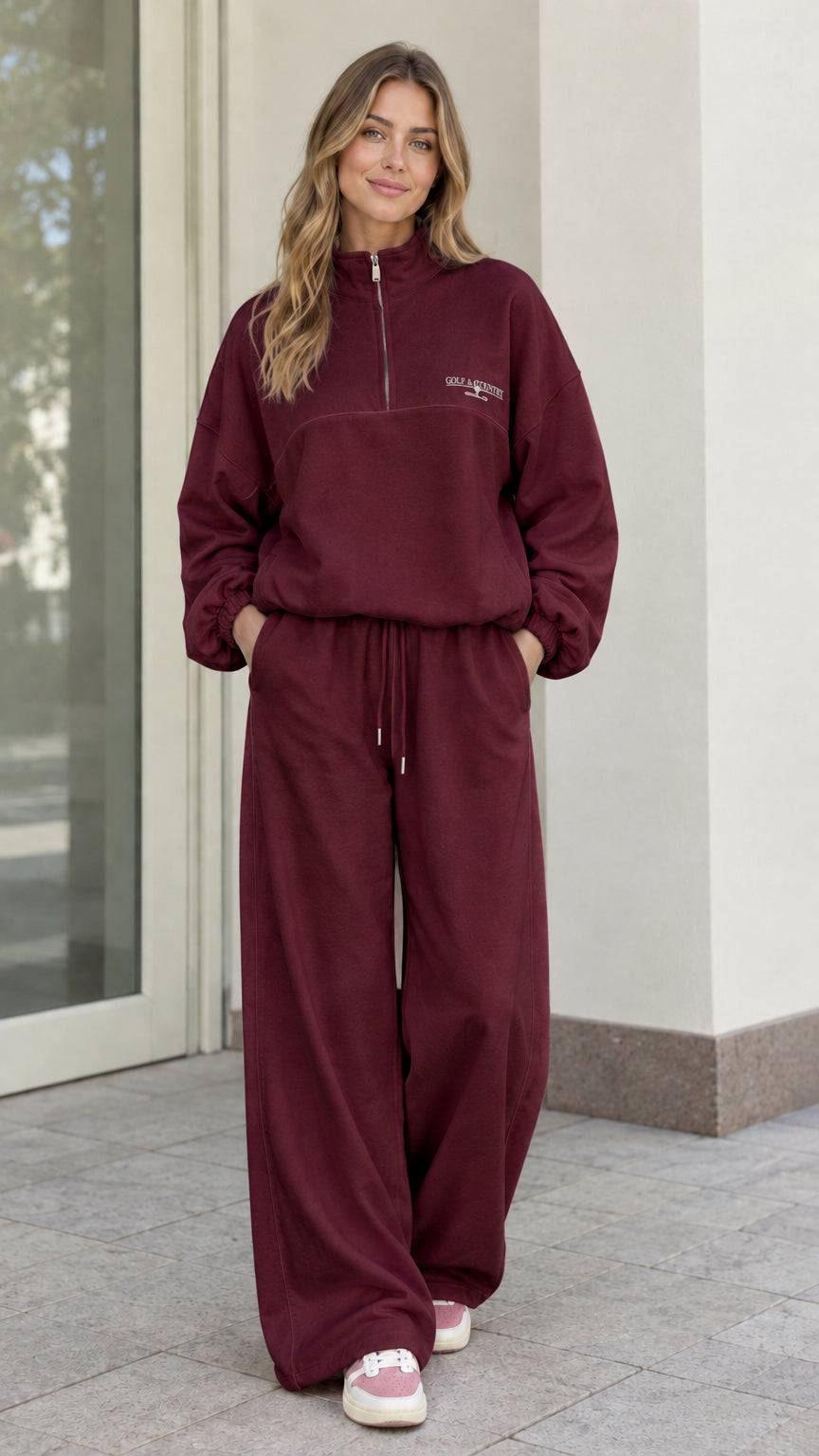 Woman wearing Burgundy fleece quarter-zip pullover and matching wide-leg pants set