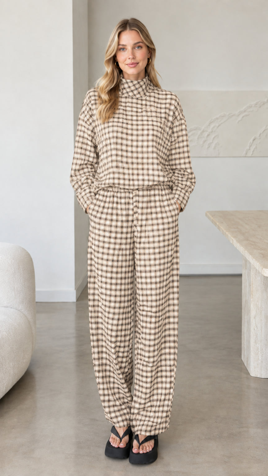 Front view of woman wearing beige cream plaid mock neck top and wide leg pants set