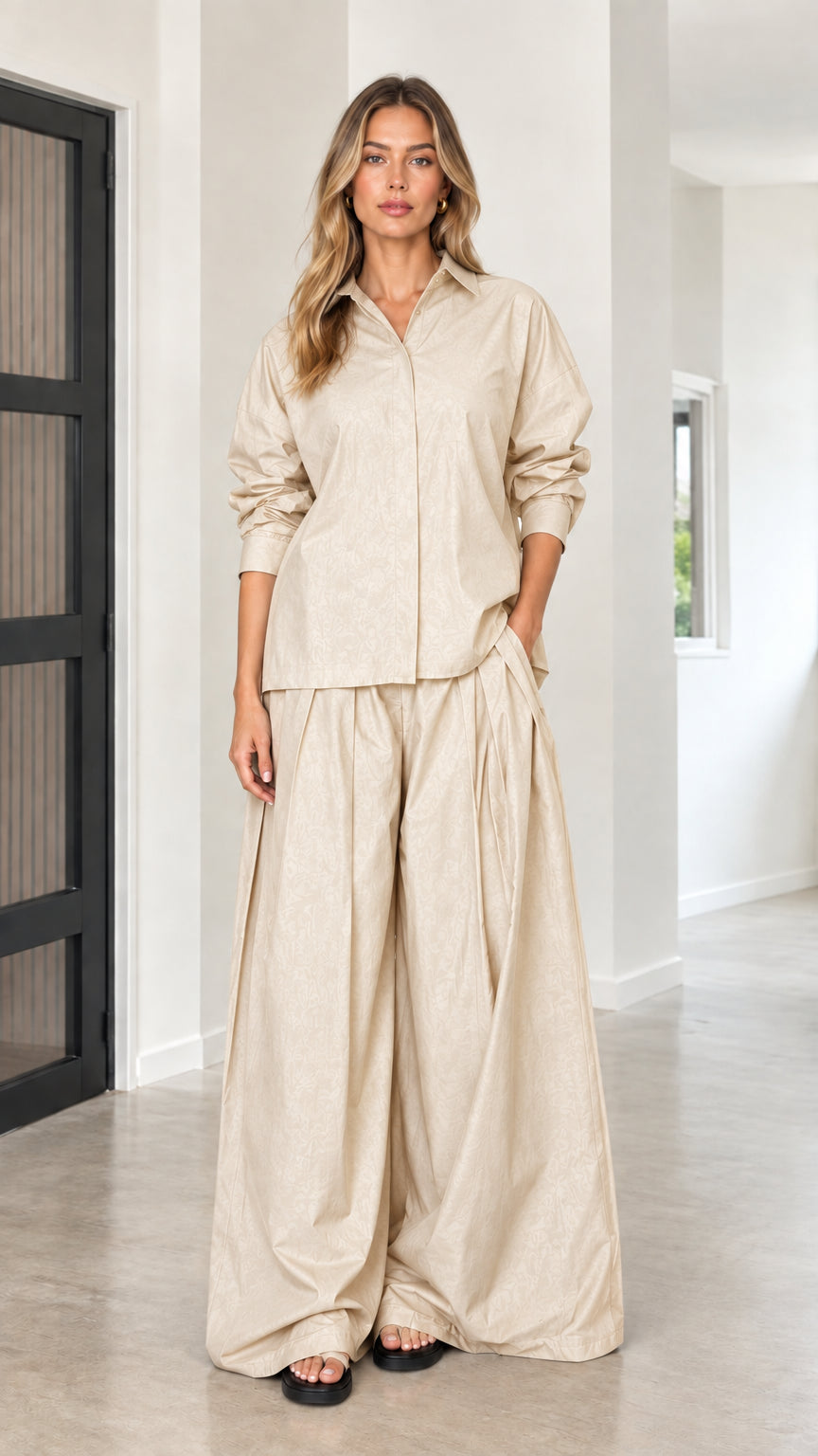 Beige neutral tone two-piece set with draped button-up top and wide-leg trousers