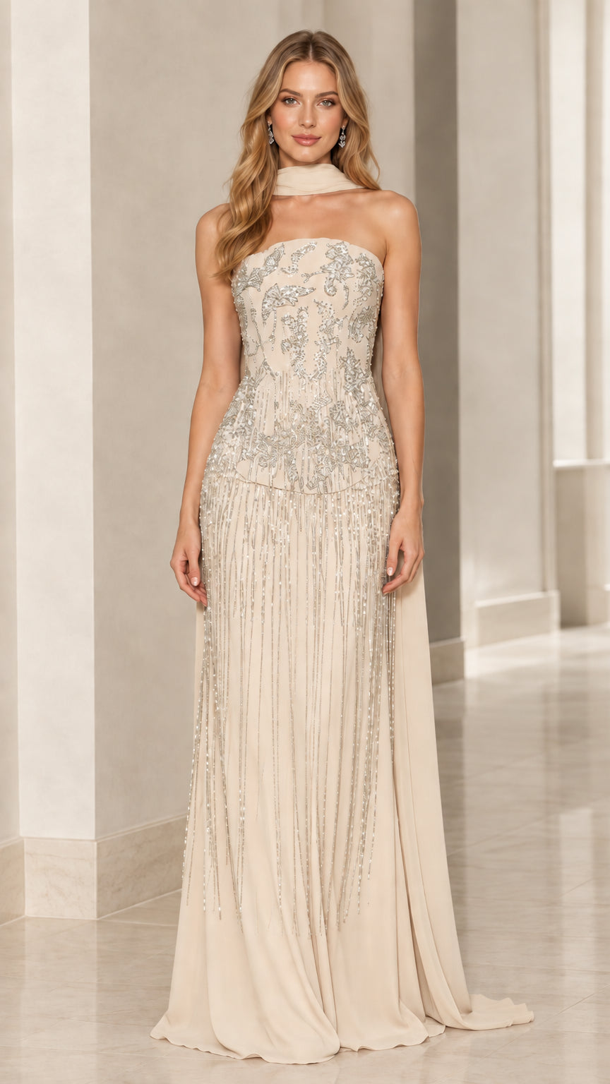 Model wearing champagne ivory strapless beaded formal gown with long scarf drape