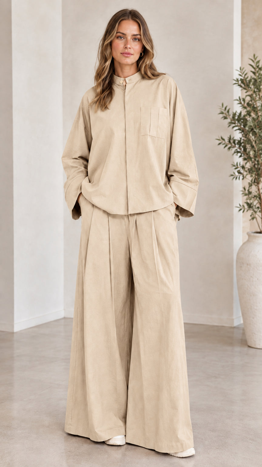 Front view of woman wearing the matching two-piece wide-leg set in beige