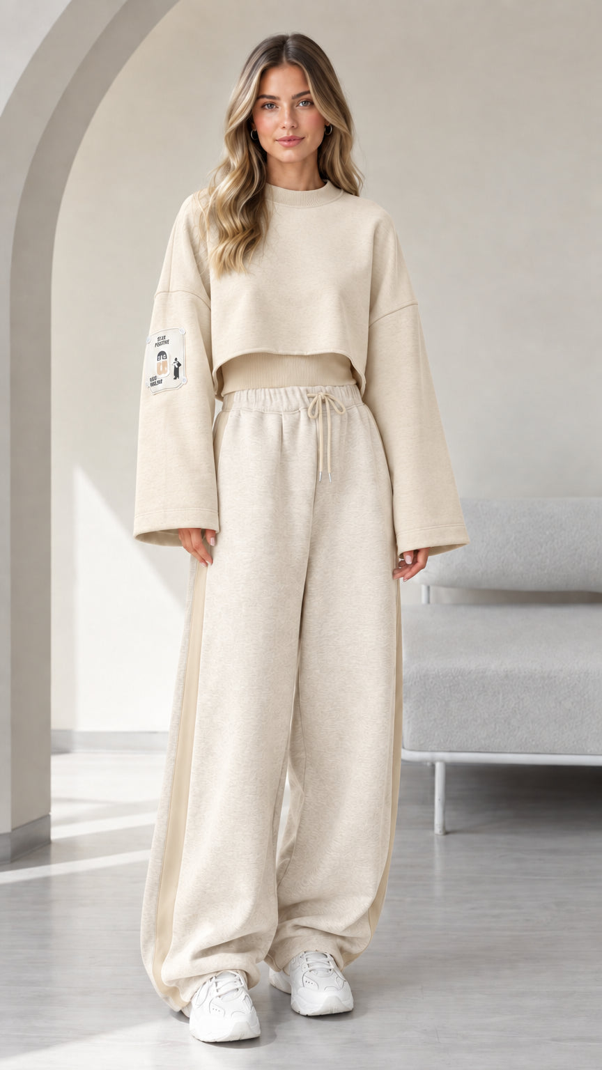 Model wearing beige monochrome cropped sweatshirt and matching wide leg sweatpants