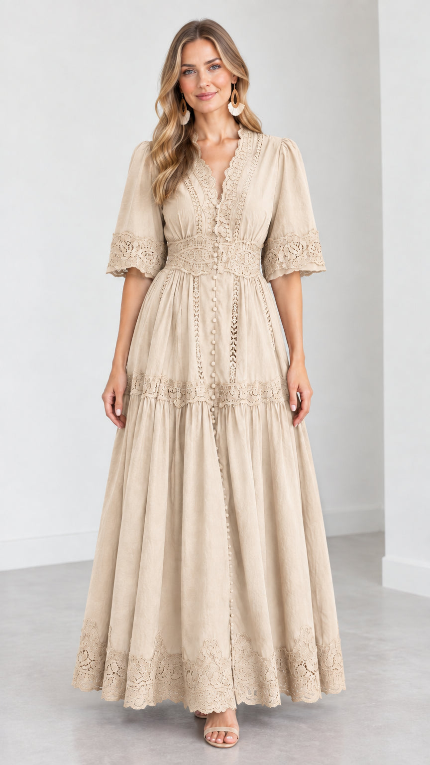 Front view of woman wearing a beige cream V-neck lace trim tiered maxi dress