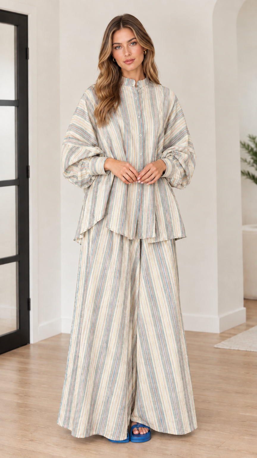 Woman wearing beige and cream vertical striped tunic and palazzo pants set