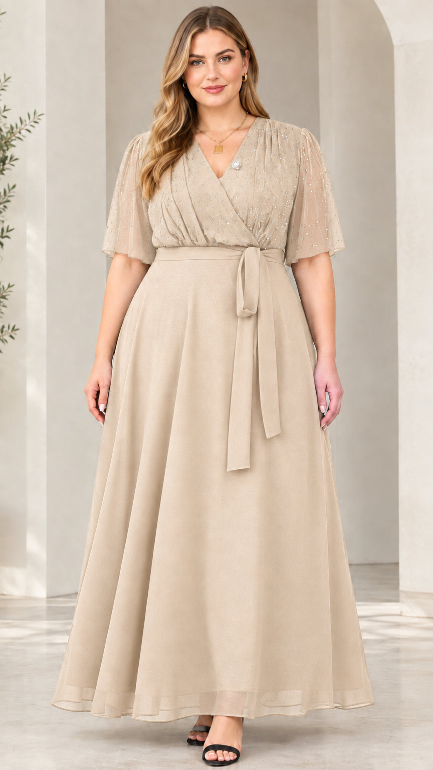Front view of model wearing champagne beige flutter sleeve glitter evening maxi dress