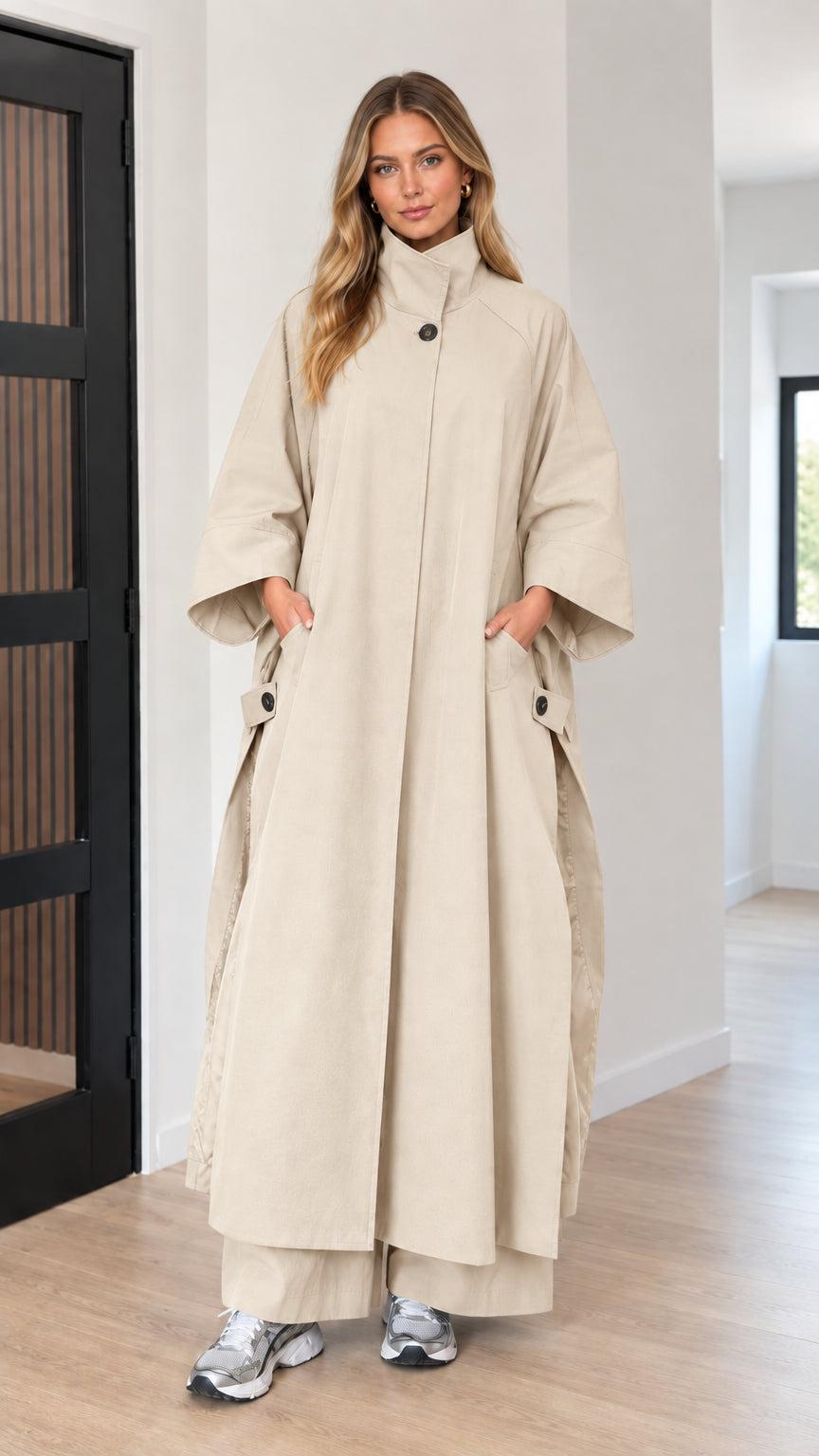 Front full-length view of woman wearing light beige oversized maxi cape coat