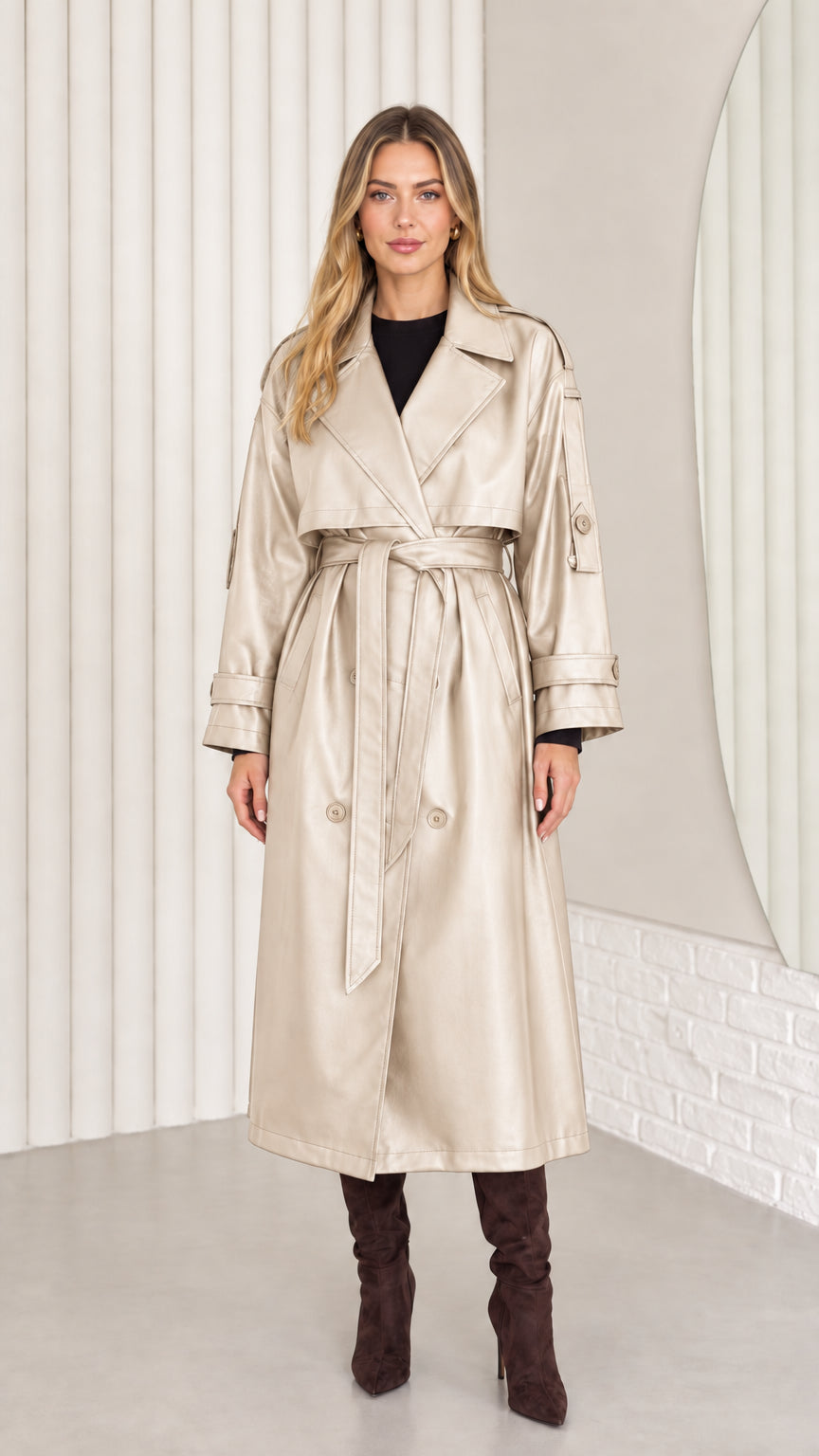 Full-length front view of woman wearing champagne beige faux leather belted trench coat