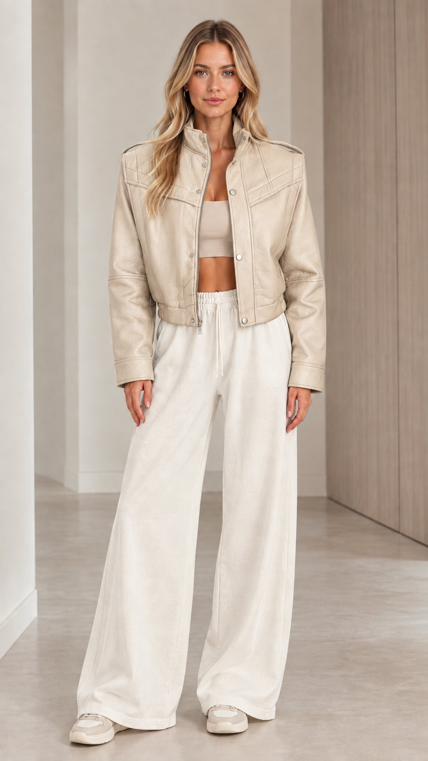 Front full view of woman wearing the cropped faux leather jacket in Beige