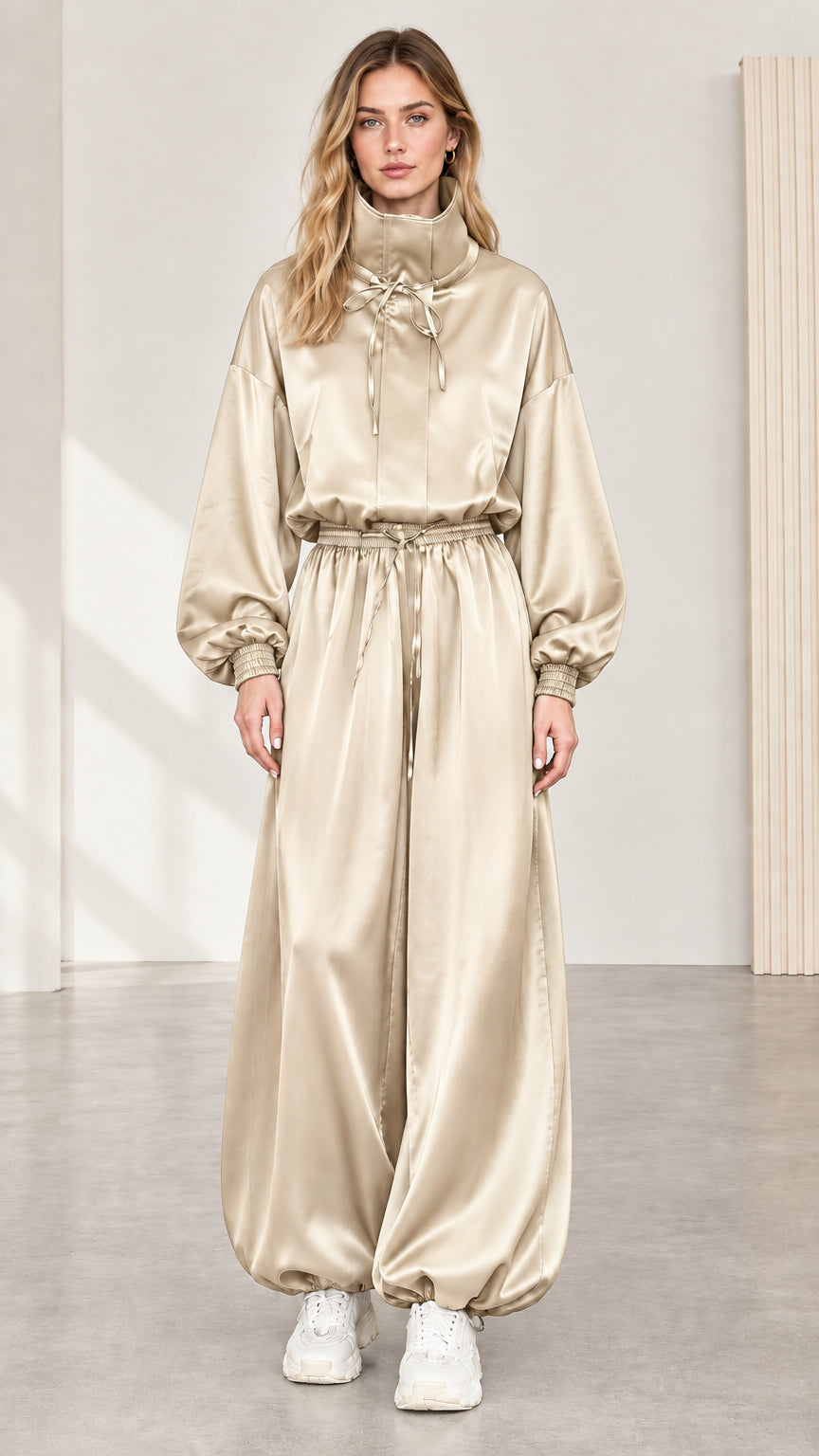 Full front view of model wearing champagne beige satin high neck balloon jumpsuit