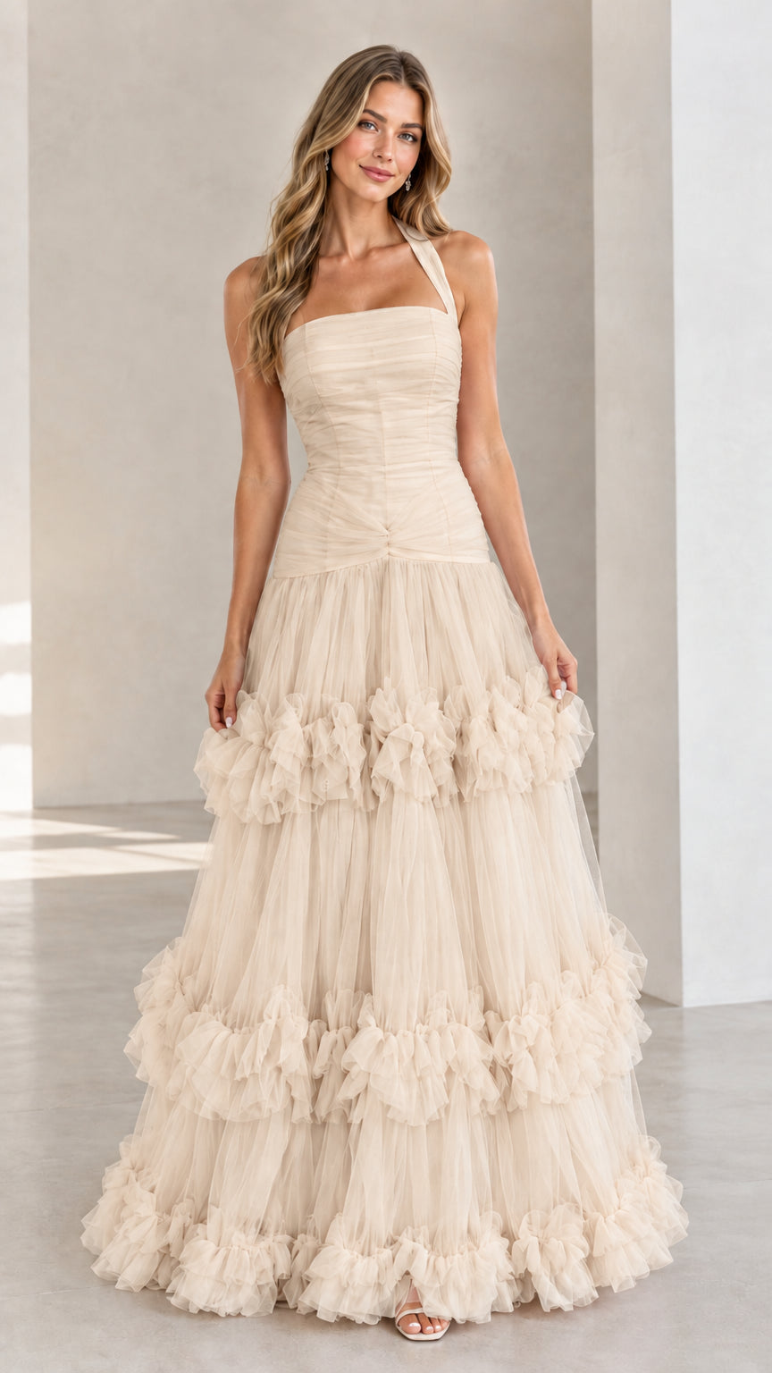 Front view of woman wearing Champagne beige halter neck tiered tulle ball gown