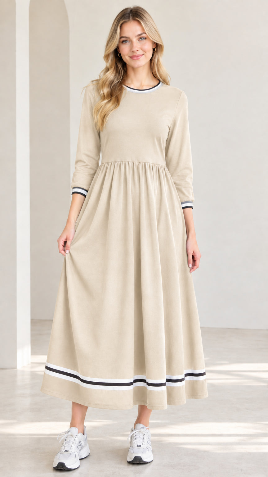 Front view of model wearing beige oatmeal 3/4 sleeve maxi dress with dark stripe trim