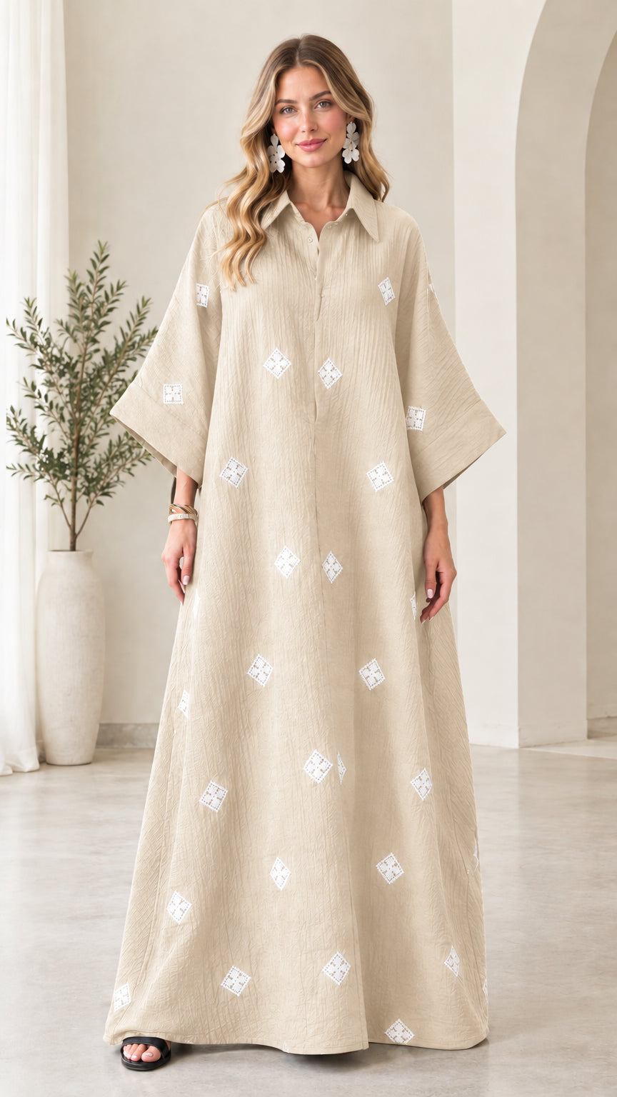 Front view of model wearing beige oatmeal embroidered crinkle maxi shirt dress