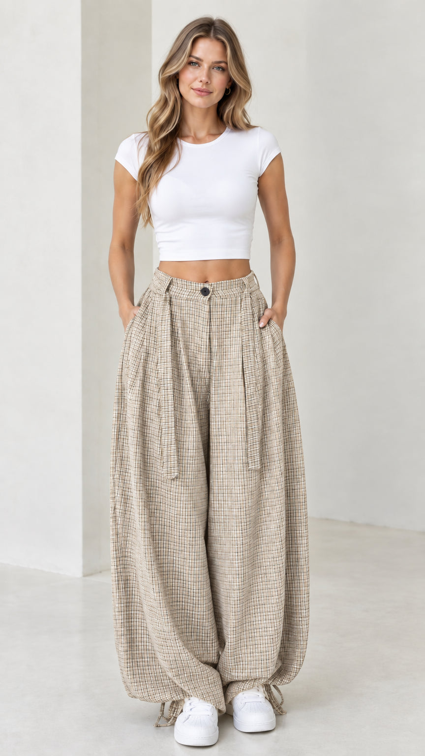 Front view of woman wearing beige oatmeal micro-plaid wide leg pleated pants