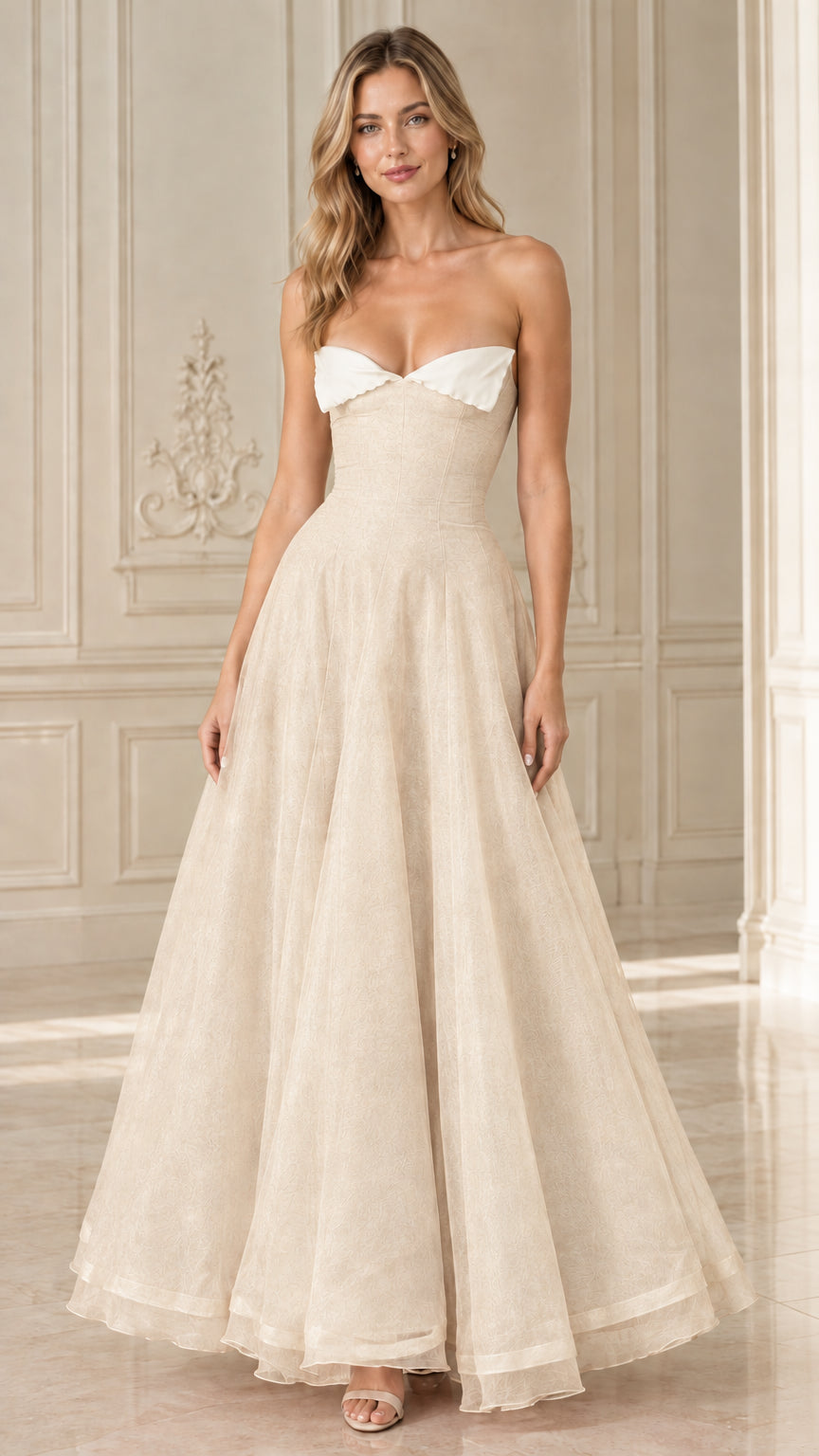 Front view of Champagne strapless formal evening gown with white foldover detail