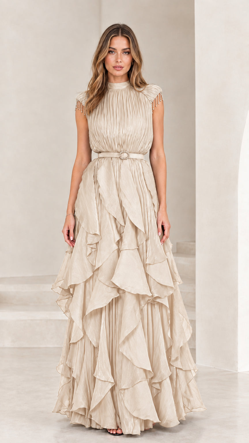 Front view of champagne cream pleated tiered ruffle evening gown