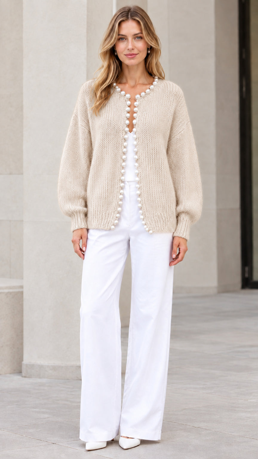 Model wearing Beige pearl-trimmed knit cardigan sweater with white trousers