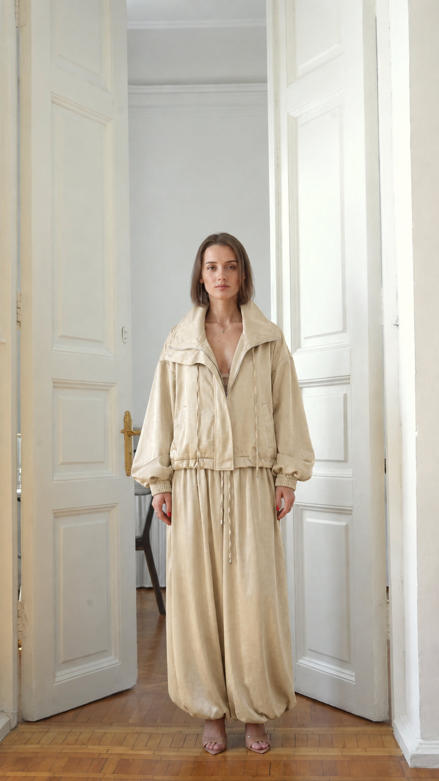 Front view of model wearing neutral beige relaxed two-piece tracksuit set