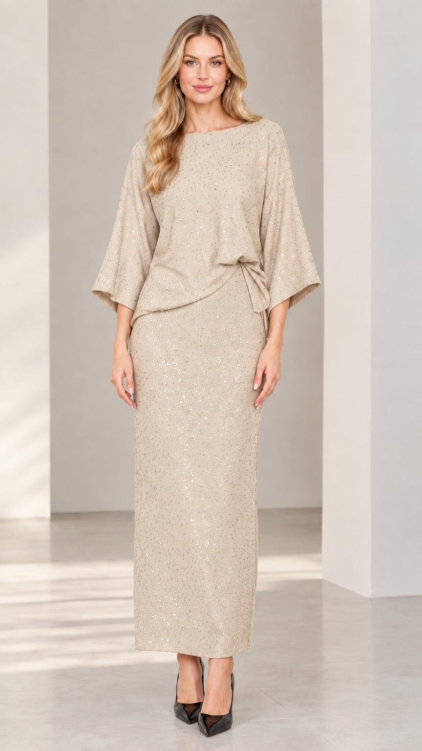 Full-length studio shot of woman modeling champagne beige glitter maxi skirt set