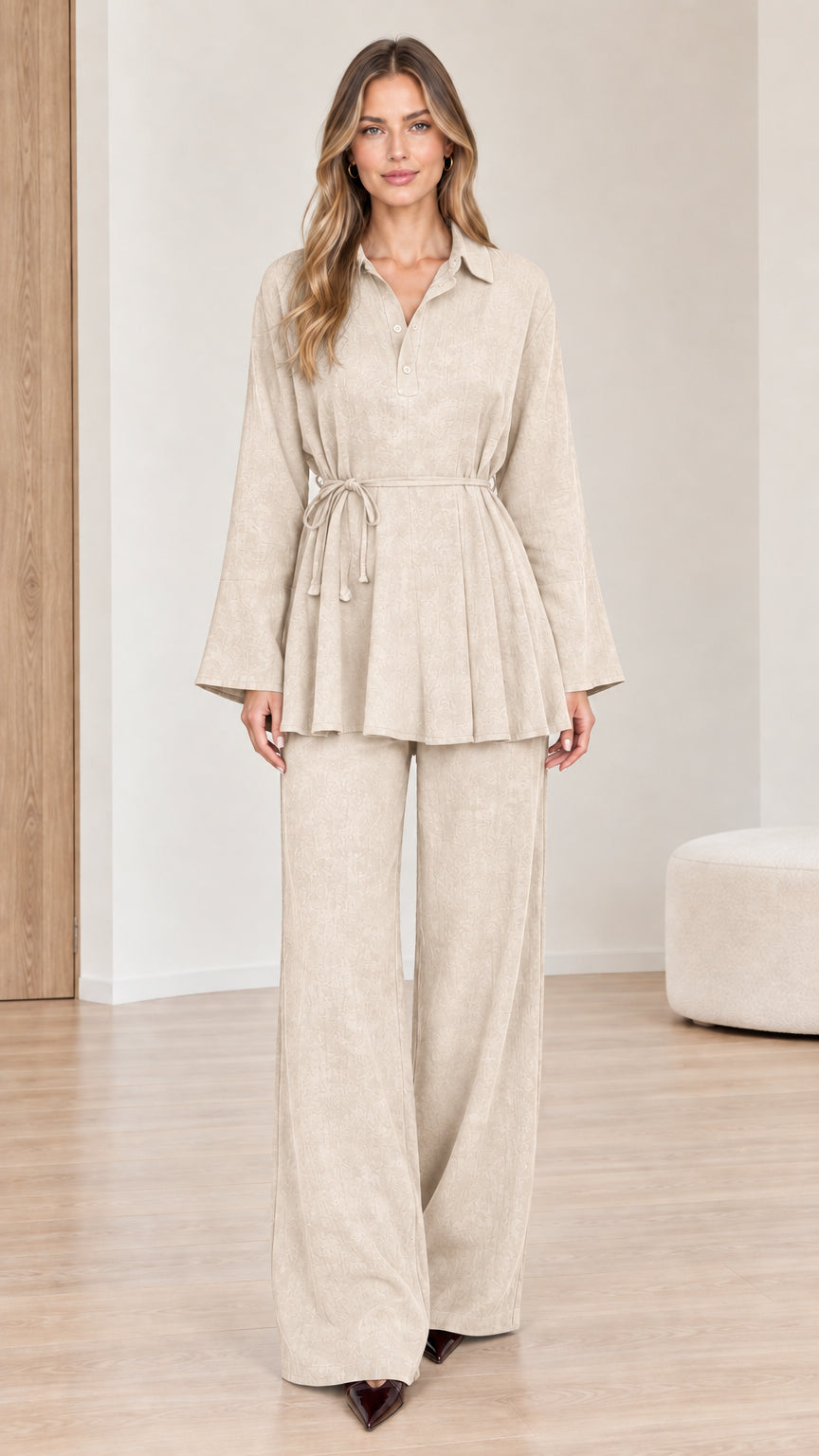 Front view of woman wearing beige belted peplum top and wide-leg pants set