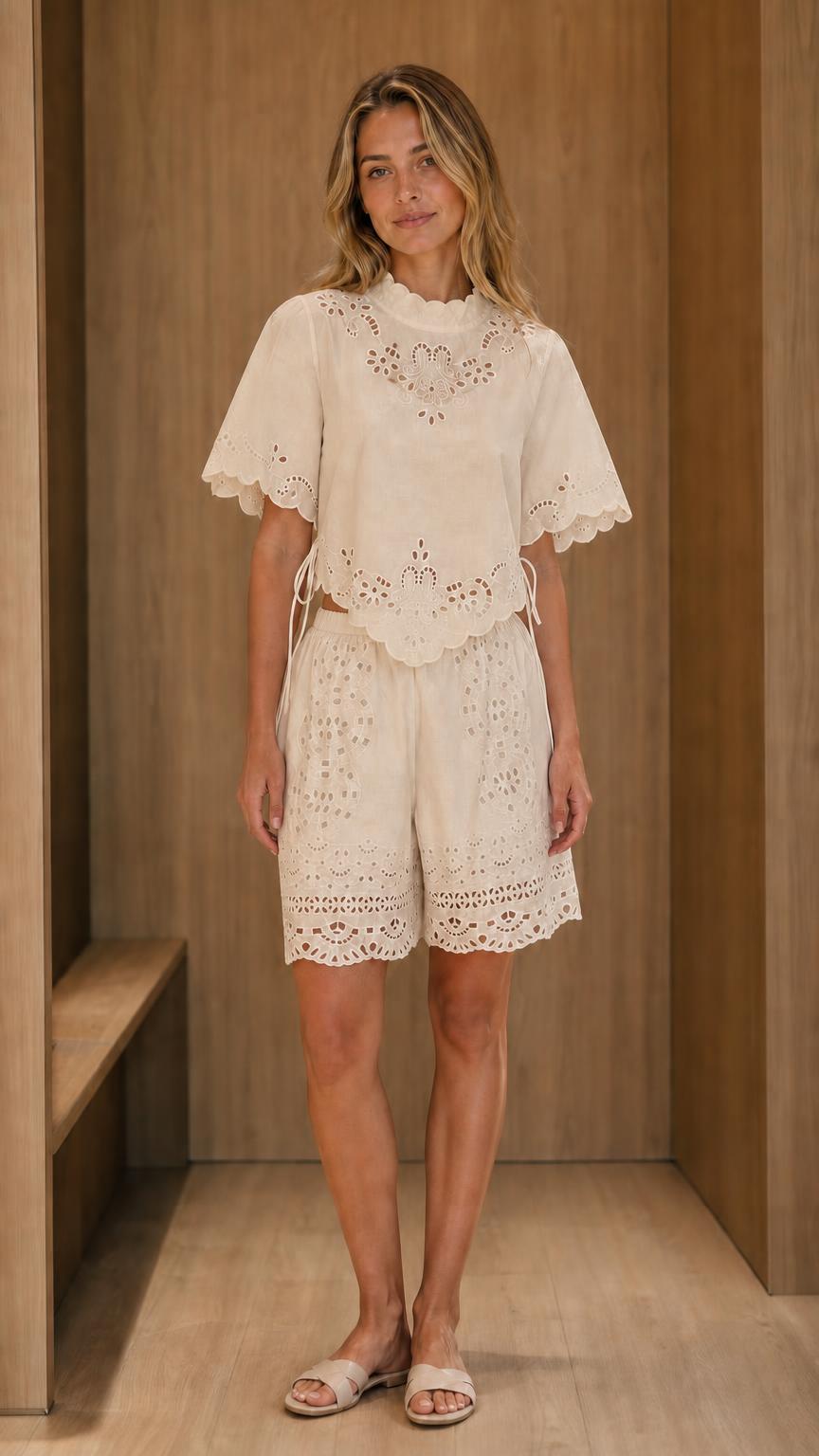 Model wearing beige eyelet embroidered top and shorts set