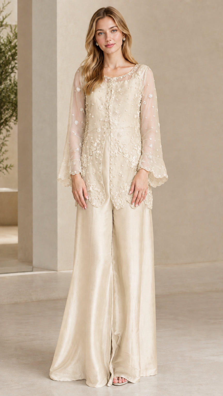 Model wearing Champagne gold embroidered tunic top and wide leg pants