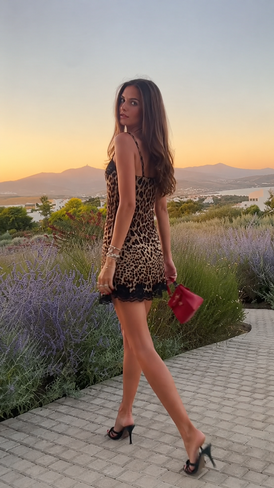 Side profile of woman in leopard print mini dress walking outdoors